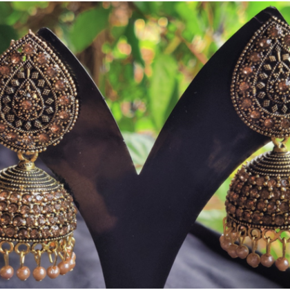Gold toned leaf shaped jhumkis with golden Pearls
